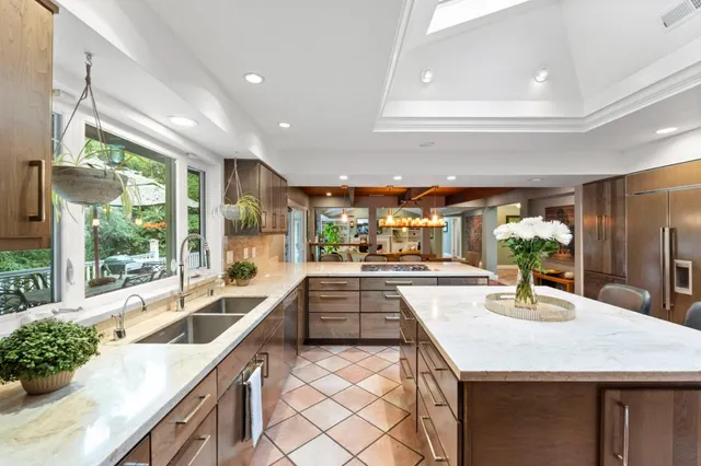 a kitchen with granite countertop a sink and stove