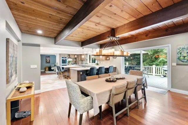 a dining room with furniture wooden floor and a rug