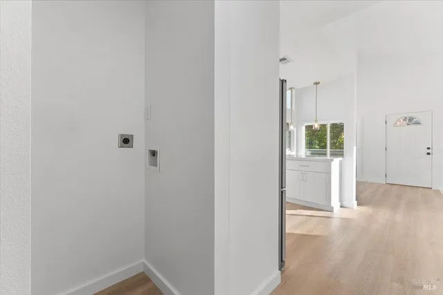 a view of a hallway with wooden floor