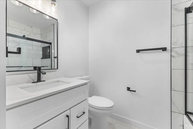 a bathroom with a sink toilet and mirror