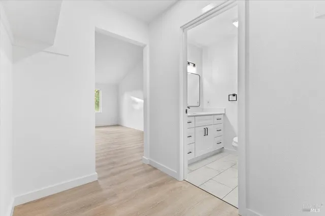wooden floor with white cabinets