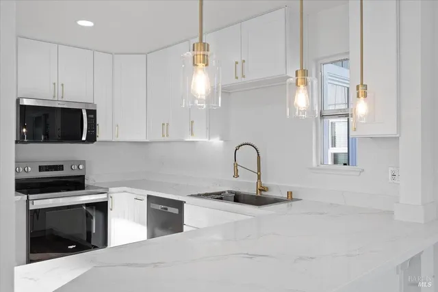 a kitchen with granite countertop a stove and a sink