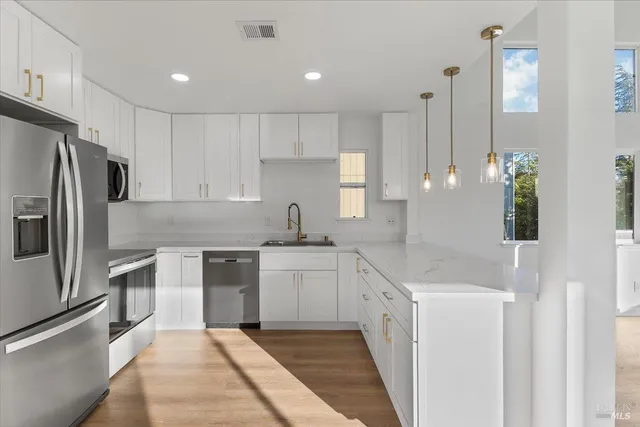 a kitchen with a sink stove and refrigerator