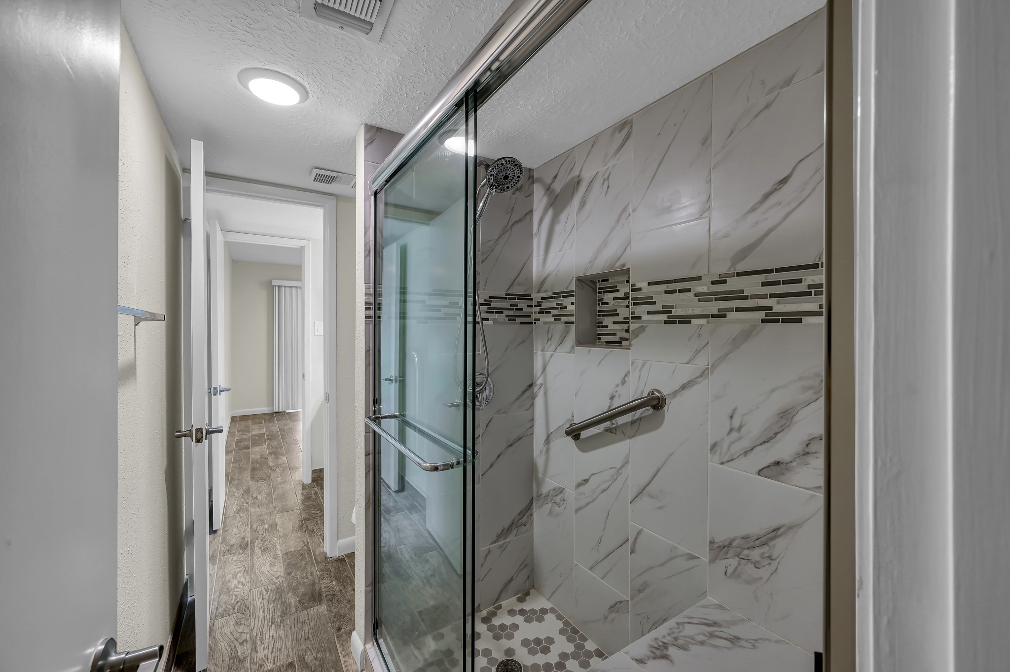 12900 Walden Road, Unit 605 Montgomery, TX 77356 - Photo 12 of 17 Updated walk in shower with tile surround and glass enclosure