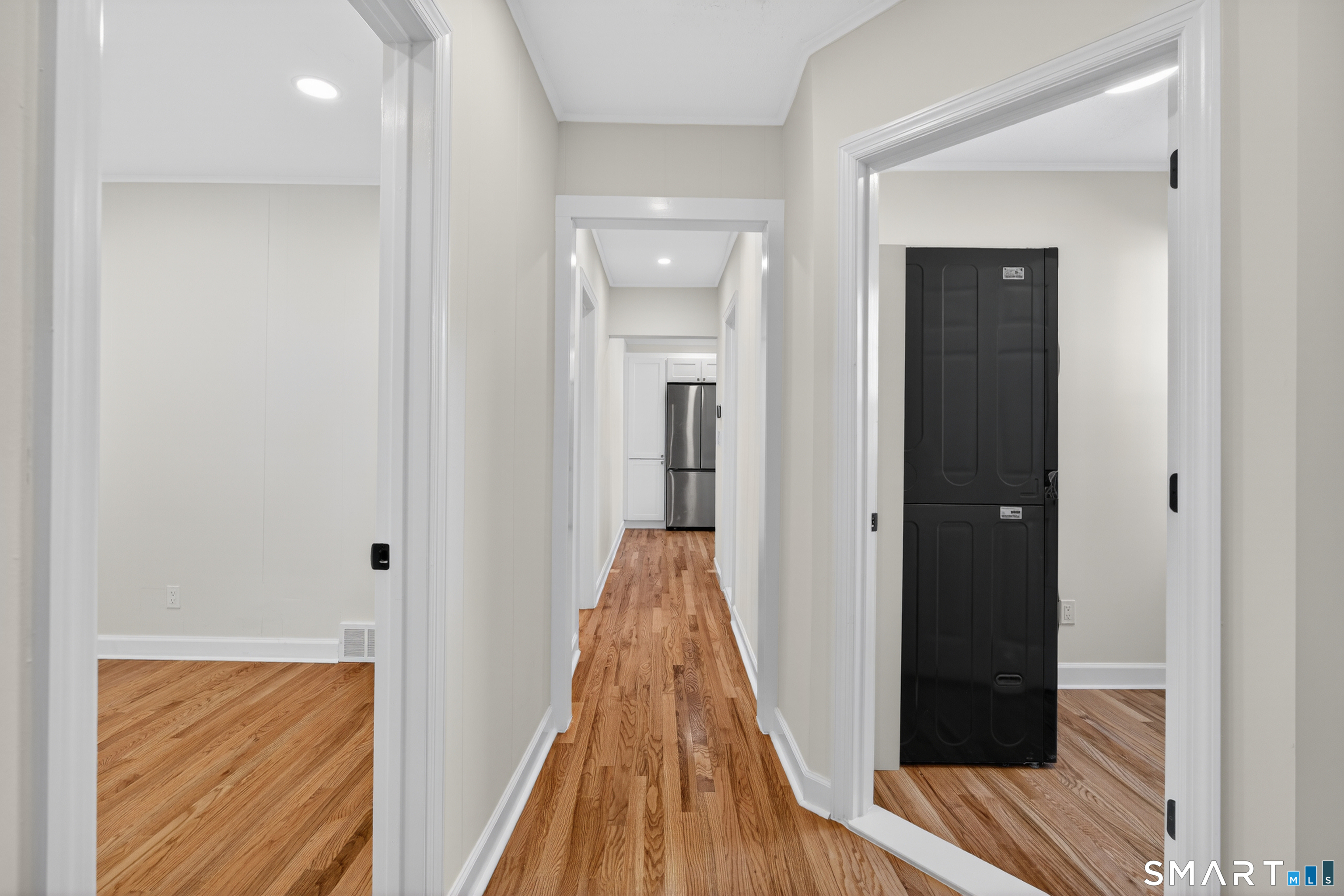 195 Laurel Place Bridgeport, CT 06604 - Photo 12 of 14 a view of a hallway with wooden floor and staircase