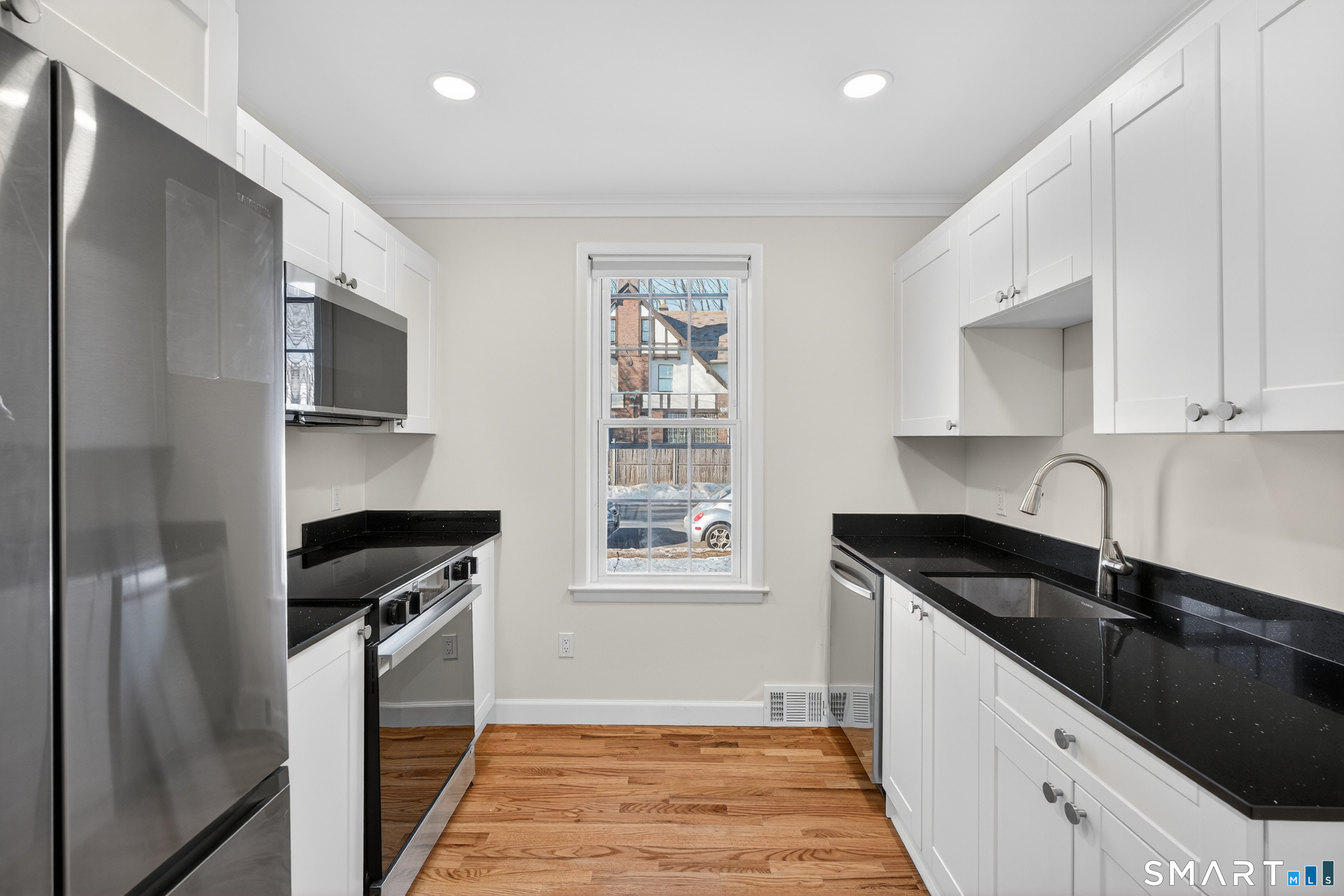 195 Laurel Place Bridgeport, CT 06604 - Photo 2 of 14 a kitchen with granite countertop a stove sink and cabinets