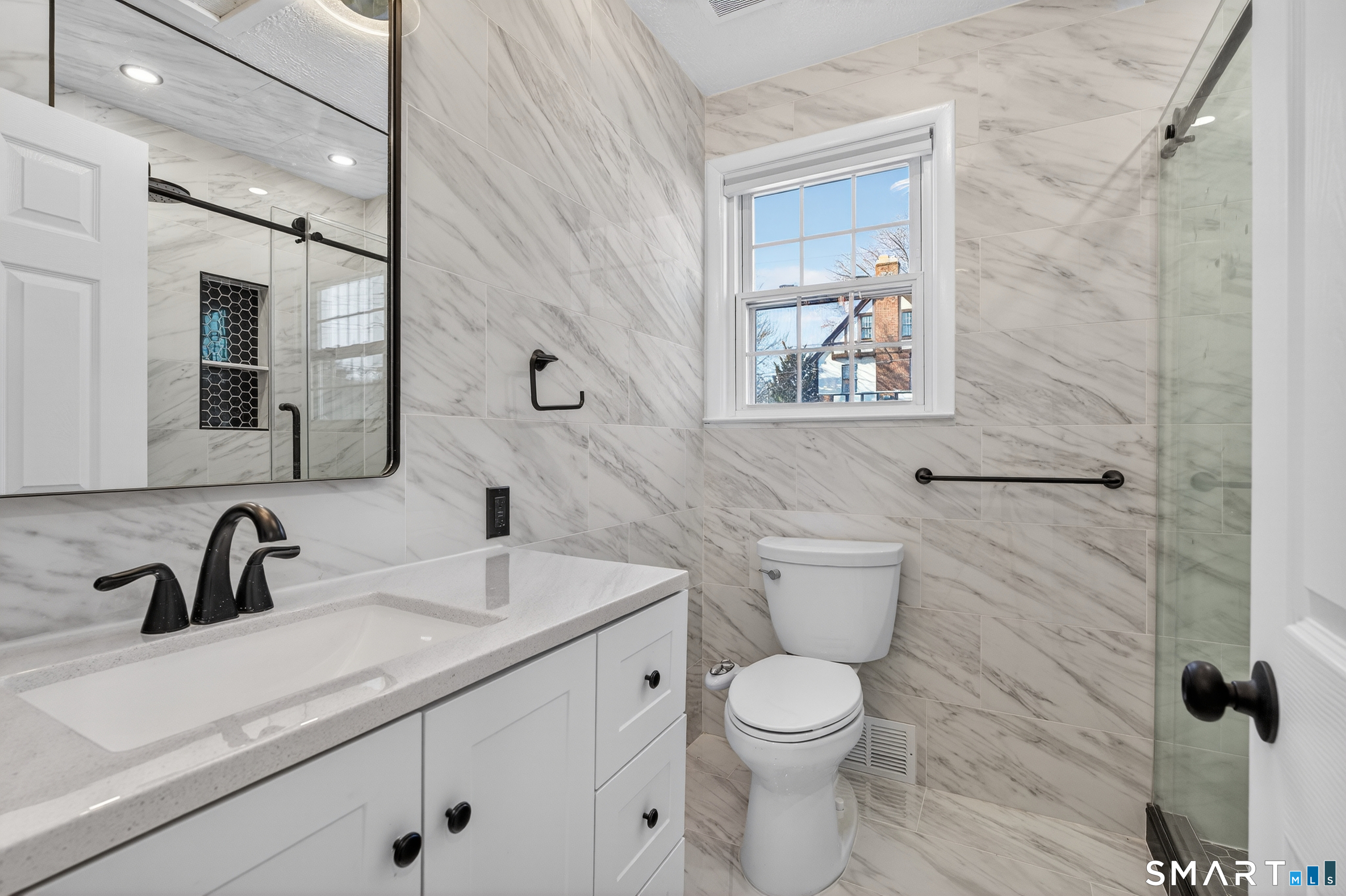 195 Laurel Place Bridgeport, CT 06604 - Photo 4 of 14 a bathroom with a toilet sink and mirror