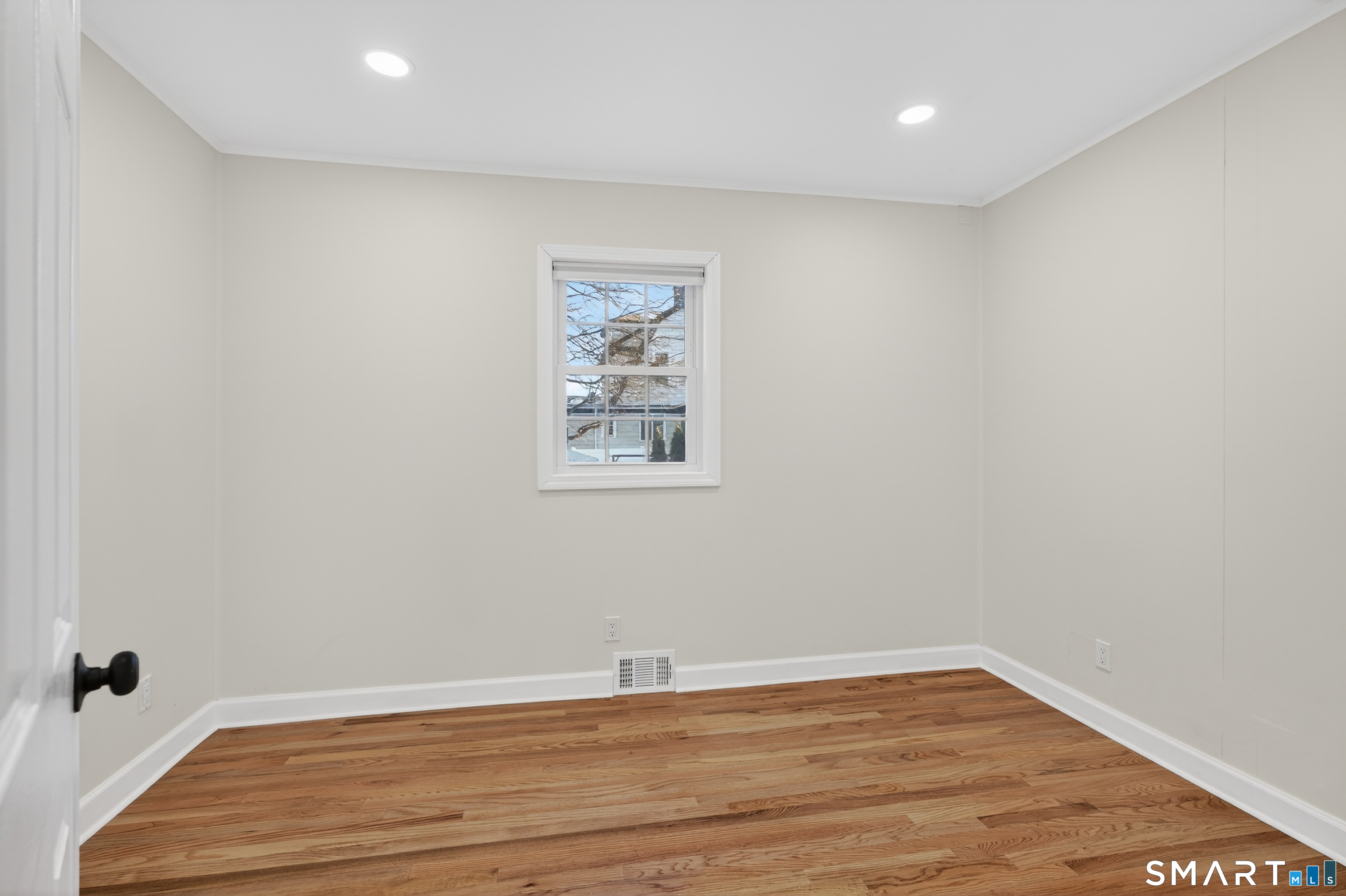 195 Laurel Place Bridgeport, CT 06604 - Photo 7 of 14 a view of a room with wooden floor and white walls