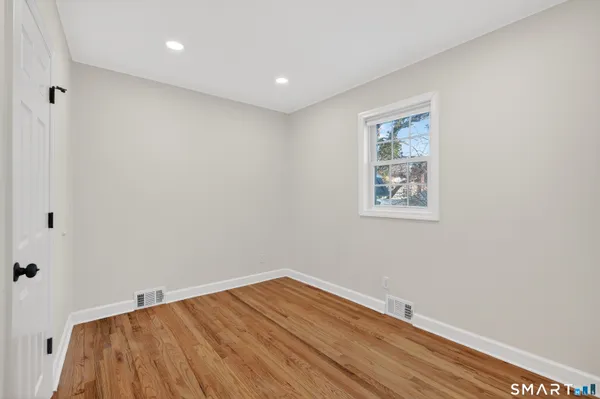 a view of room with wooden floor and fan