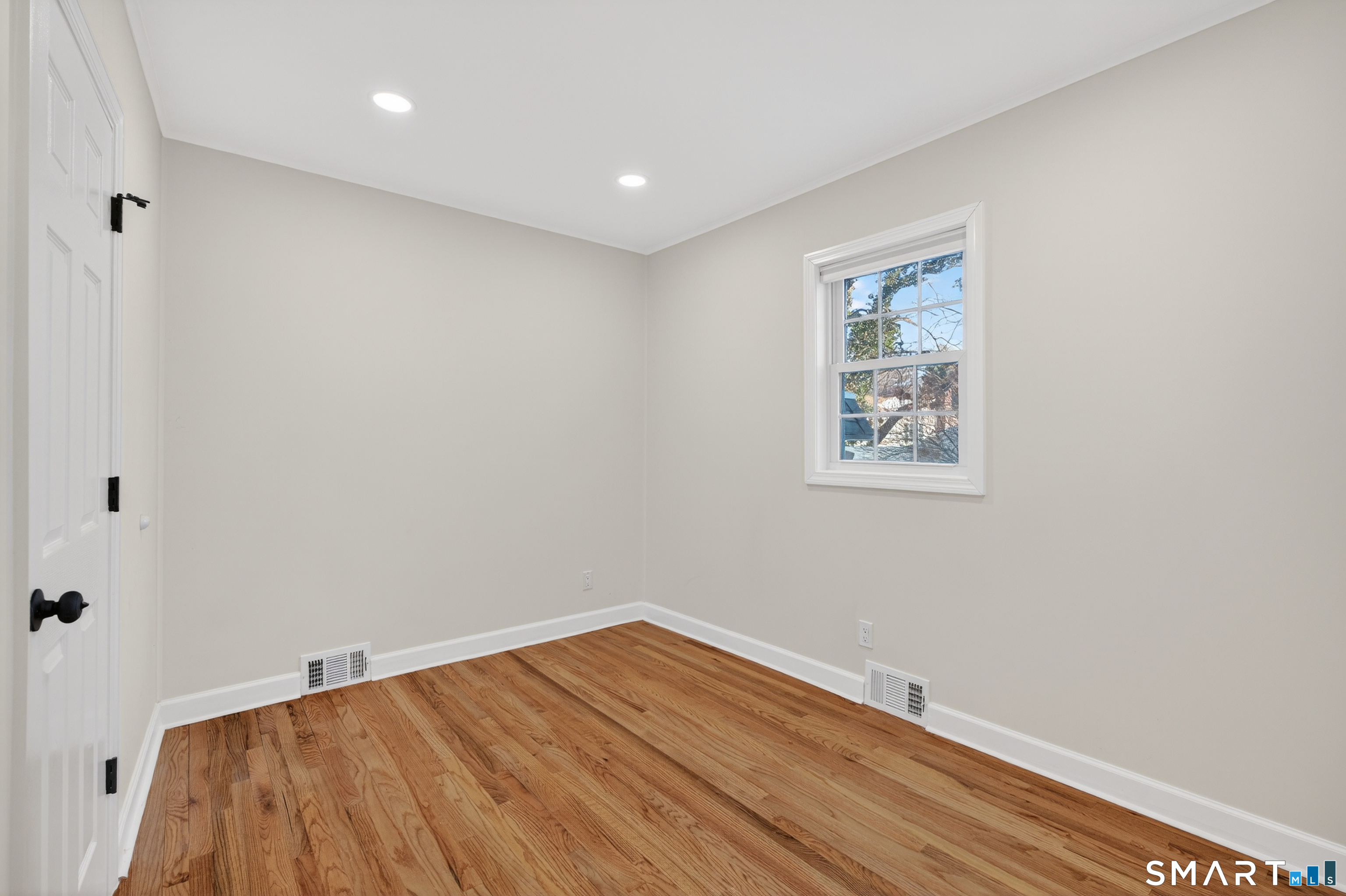 195 Laurel Place Bridgeport, CT 06604 - Photo 8 of 14 a view of room with wooden floor and fan
