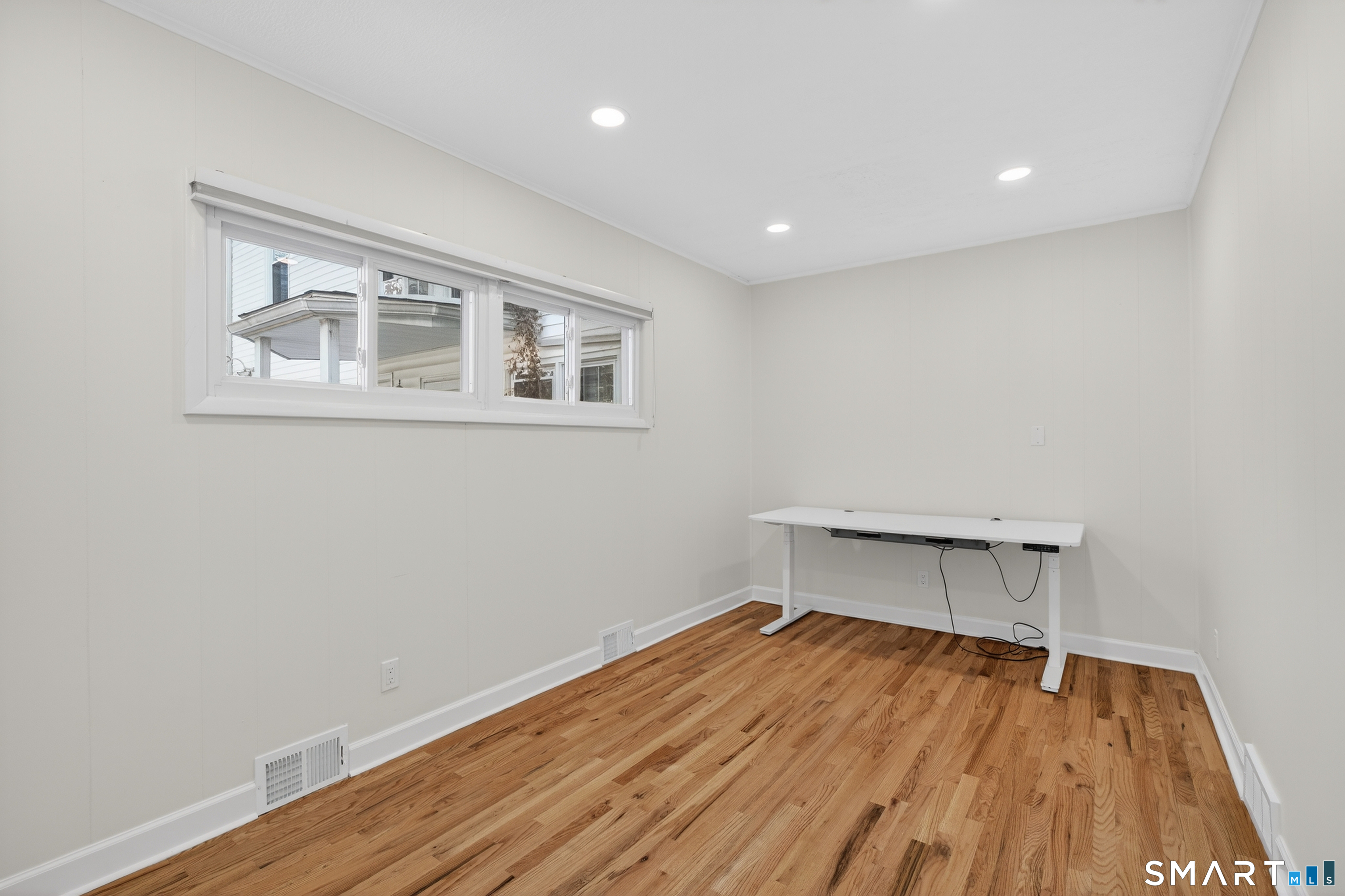 195 Laurel Place Bridgeport, CT 06604 - Photo 9 of 14 a view of room with wooden floor and fan