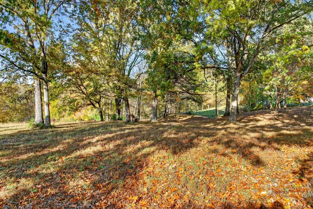 a view of a balcony with wooden floor and fence