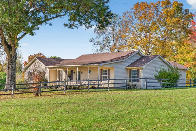 a front view of house with yard and green space