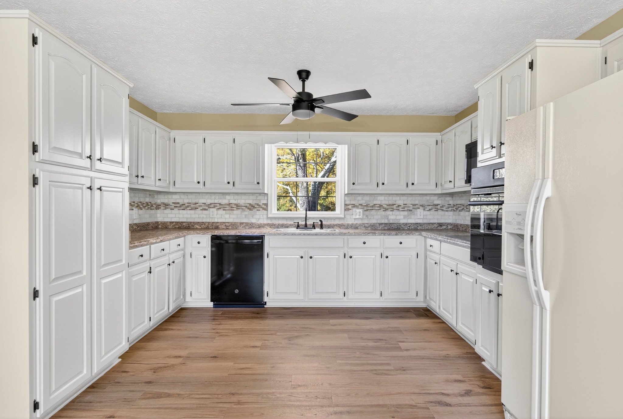 226 West Biggs Road Cottontown, TN 37048 - Photo 38 of 56 a kitchen with granite countertop a white refrigerator oven a sink and cabinets