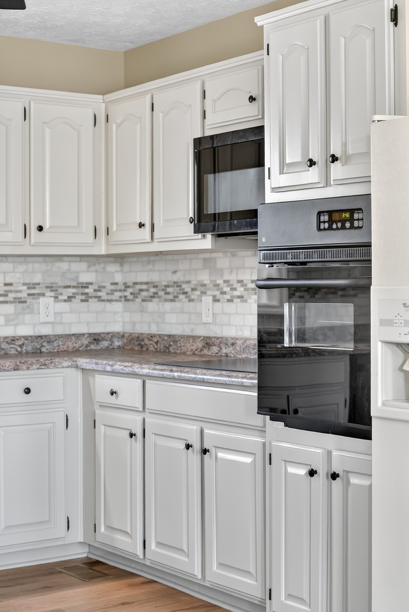 226 West Biggs Road Cottontown, TN 37048 - Photo 42 of 56 a kitchen with granite countertop white cabinets and stainless steel appliances