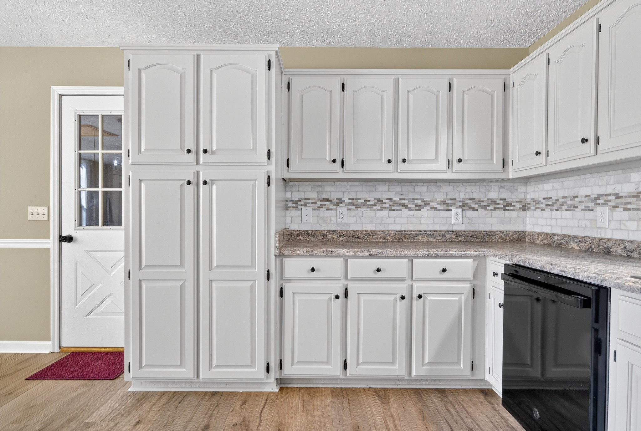 226 West Biggs Road Cottontown, TN 37048 - Photo 43 of 56 a kitchen with white cabinets and white appliances