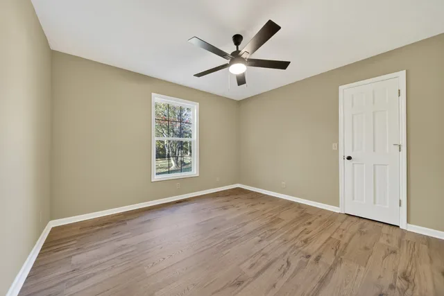 a view of room with wooden floor and staircase