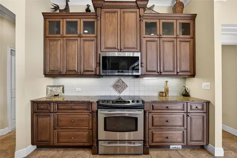 a kitchen with granite countertop a sink and a refrigerator