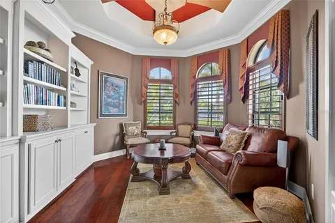 a hallway with cabinets and wooden floor