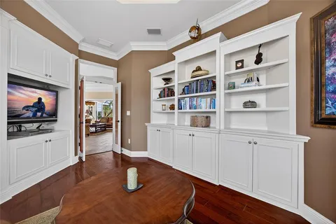 a bedroom with furniture and a large window