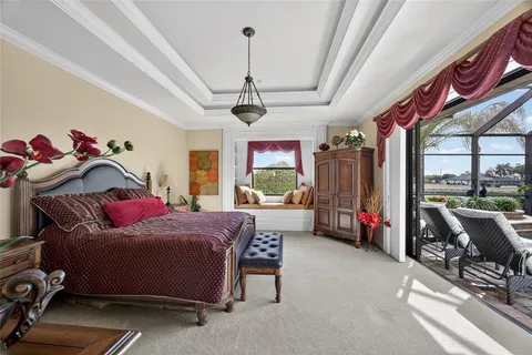 a bedroom with a bed and dresser with mirror