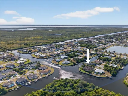 an aerial view of a house with a yard and a fountain