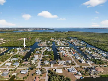 an aerial view of a house with garden space and swimming pool