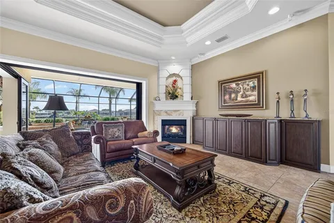a living room with furniture and a floor to ceiling window