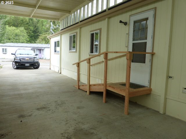 100 River Bend Road, Unit 65 Reedsport, OR 97467 - Photo 17 of 21 a view of backyard with car parked
