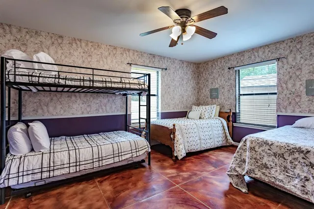 a bedroom with two beds and window