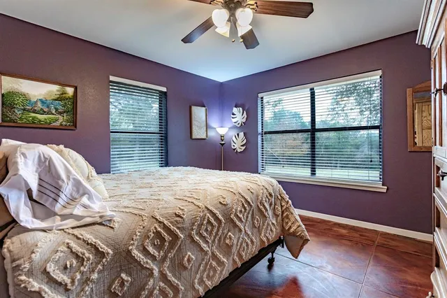 a bedroom with a large bed and a large window