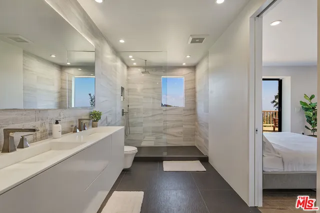 a bathroom with a sink a tub and a mirror