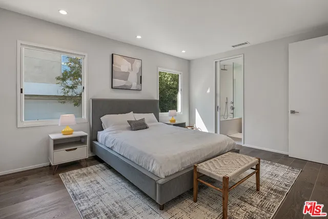 a spacious bedroom with a bed and a window