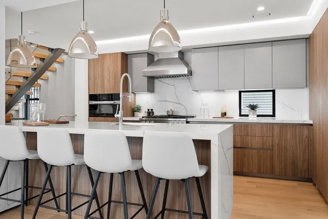 a kitchen with stainless steel appliances a table chairs and a chandelier