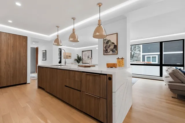 a kitchen with stainless steel appliances granite countertop a sink and a refrigerator