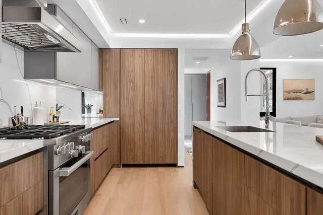 a kitchen with stainless steel appliances granite countertop a sink and stove