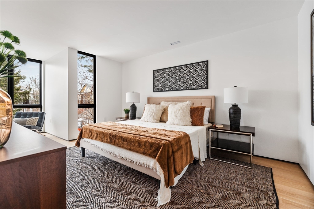 80 Alpine Street Cambridge, MA 02138 - Photo 17 of 41 a bedroom with a bed and wooden floor