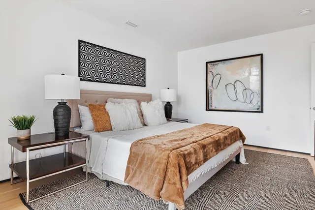 a bedroom with bed and wall painting