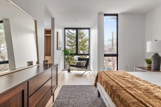 a bed room with a bed and a large window