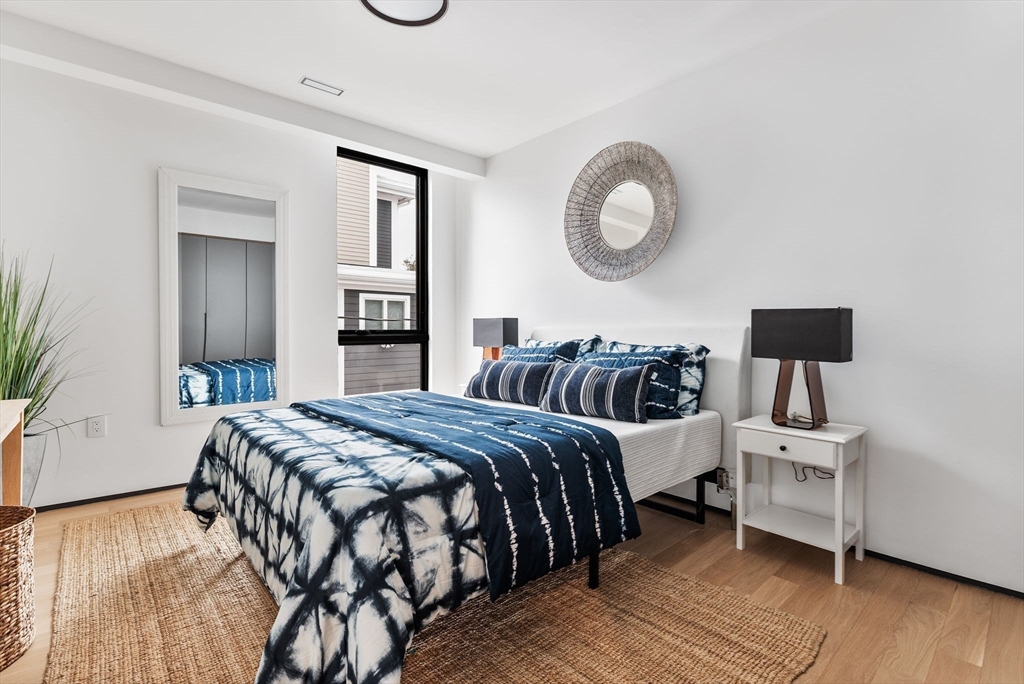 80 Alpine Street Cambridge, MA 02138 - Photo 21 of 41 a bedroom with a bed and wooden floor