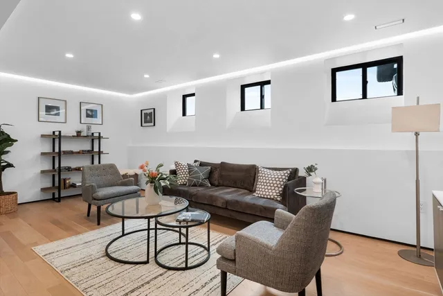 a living room with furniture and potted plant