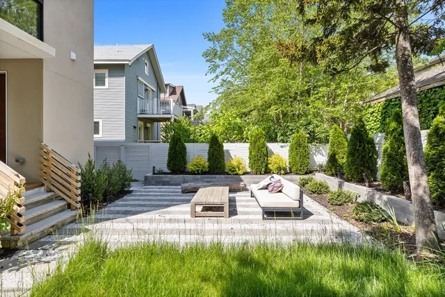 a front view of a house with plants