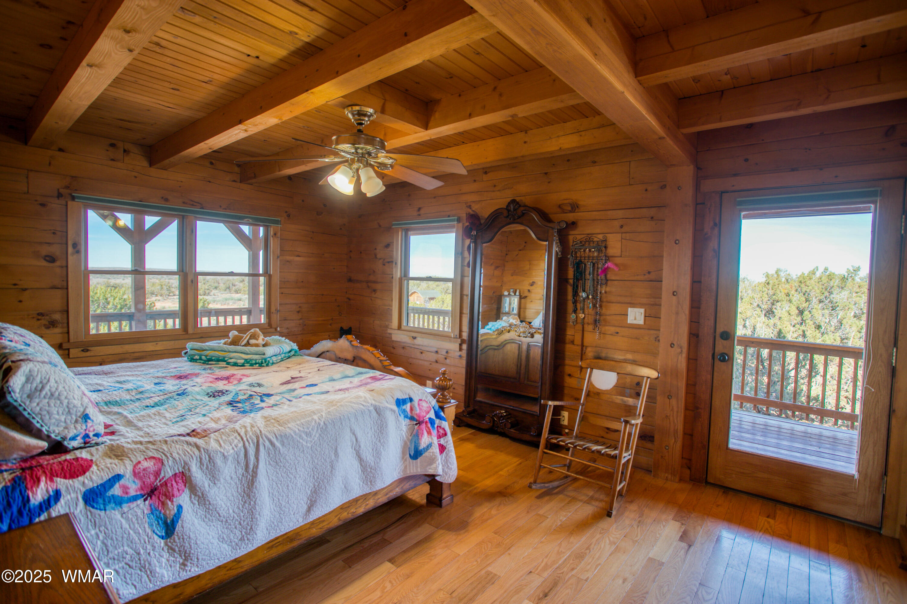 8555 Reata Lane Snowflake, AZ 85937 - Photo 26 of 88 a bedroom with a bed and a large window with chair