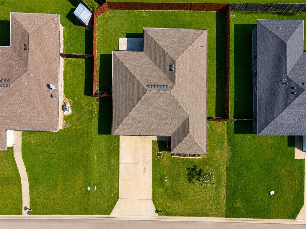 2003 Firefly Circle Waco, TX 76705 - Photo 27 of 29 Property featuring a large, manicured lawn with mature privacy fencing