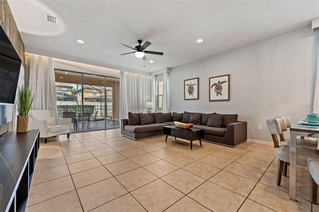 2108 Morocco Way Kissimmee, FL 34747 - Photo 25 of 57 a living room with furniture and a flat screen tv