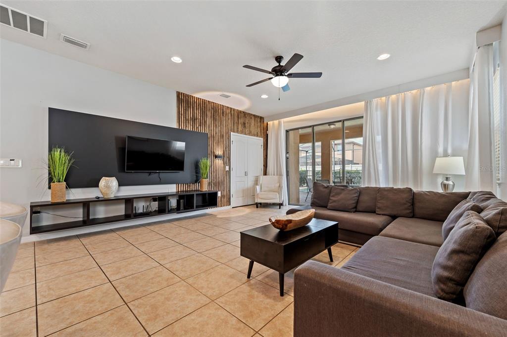 2108 Morocco Way Kissimmee, FL 34747 - Photo 26 of 57 a living room with furniture and a flat screen tv