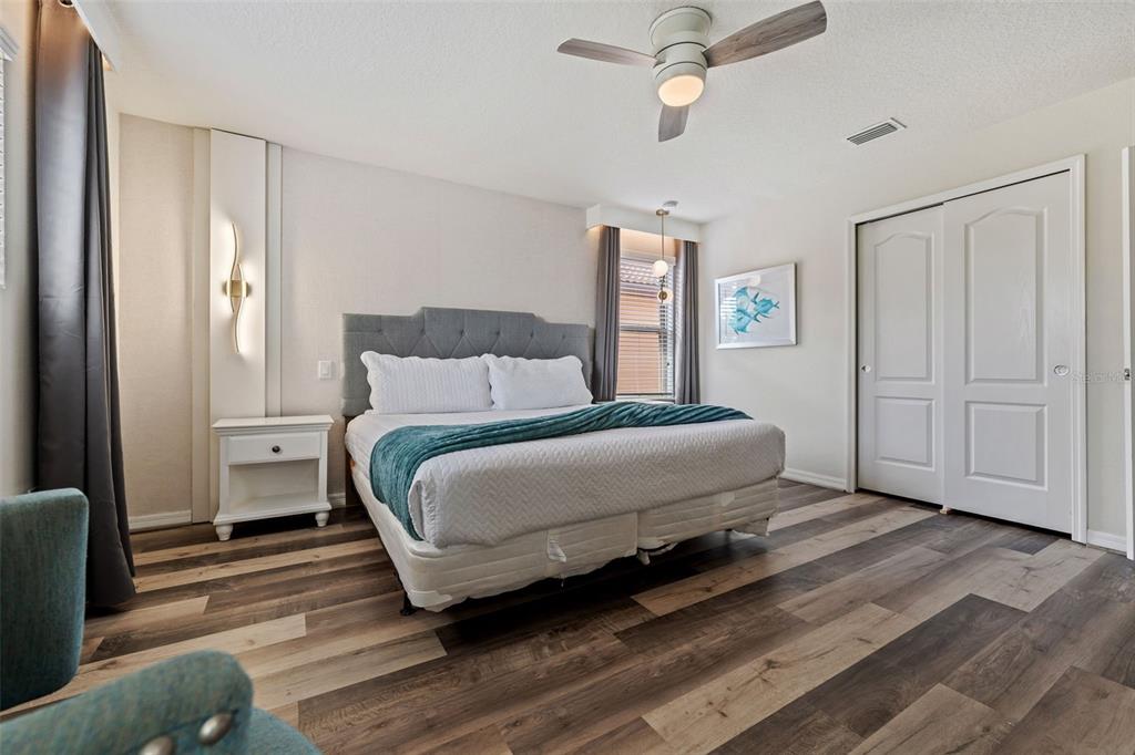 2108 Morocco Way Kissimmee, FL 34747 - Photo 29 of 57 a bedroom with a bed and wooden floor