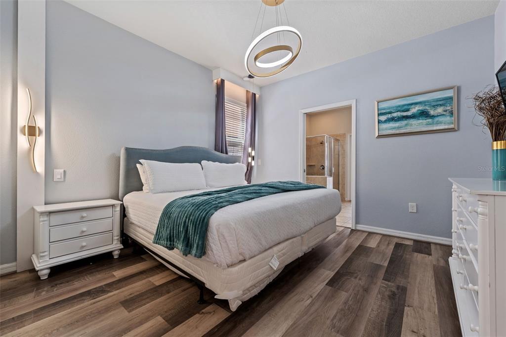 2108 Morocco Way Kissimmee, FL 34747 - Photo 33 of 57 a bedroom with a bed lamp and a window