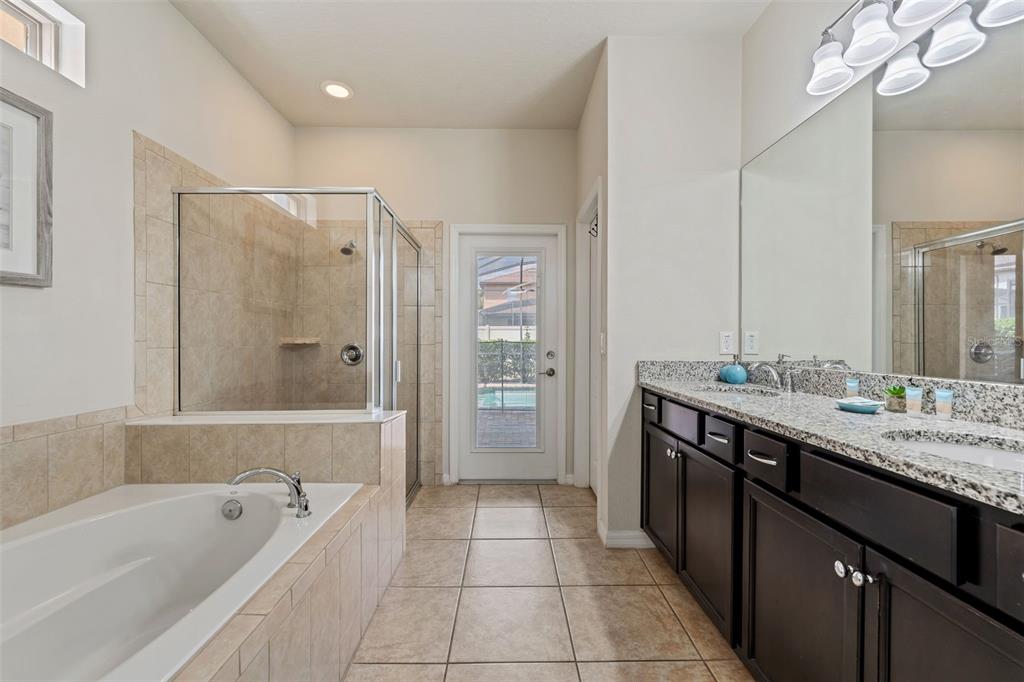 2108 Morocco Way Kissimmee, FL 34747 - Photo 35 of 57 a bathroom with a tub a sink and a mirror