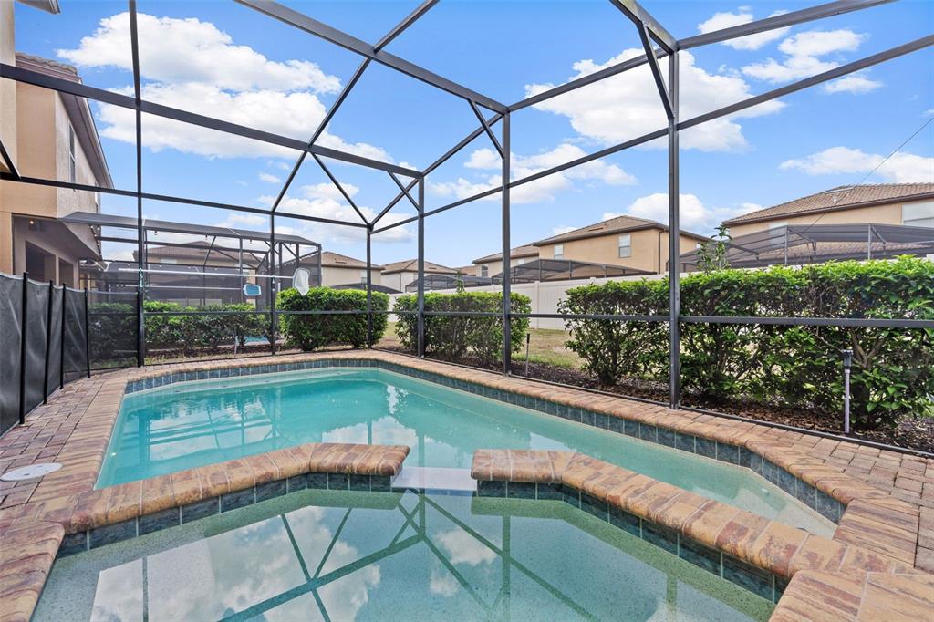 2108 Morocco Way Kissimmee, FL 34747 - Photo 5 of 57 a view of a swimming pool with a patio and a yard